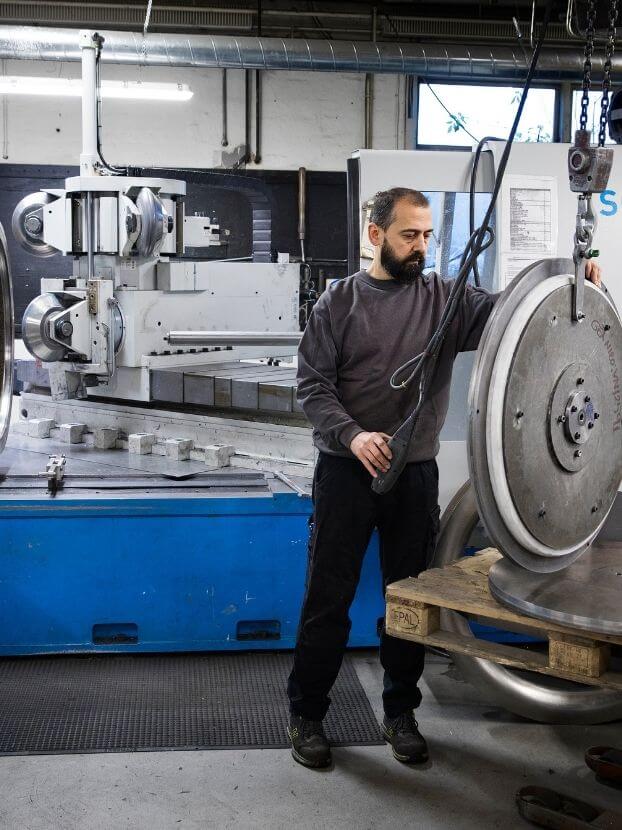 metal worker at a metal CNC machine at Olsen Metal